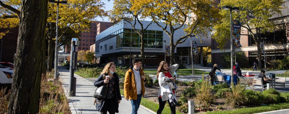 Students walk in a campus courtyard.