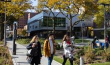 Students walk in a campus courtyard.