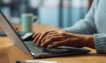 A person typing at a laptop.