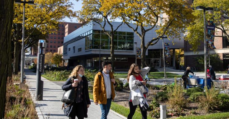 Students walk in a campus courtyard.