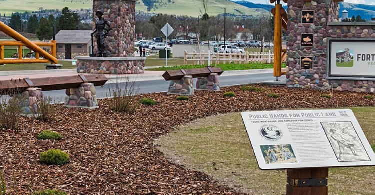 An informational plaque in front of a park