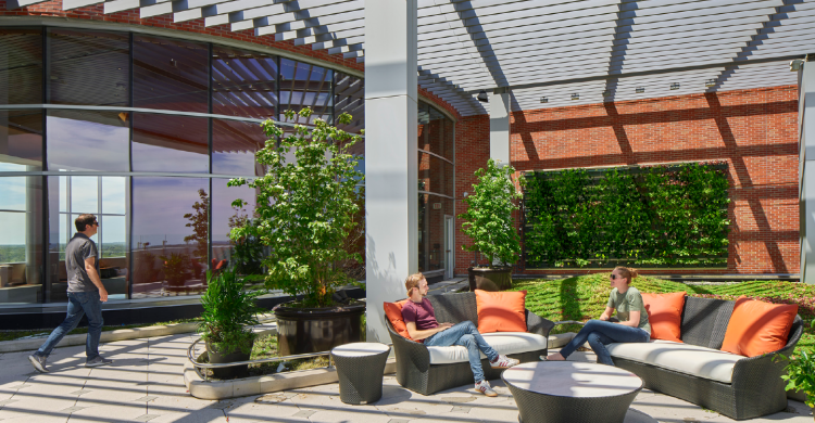 People walking across a patio next to a building