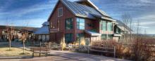 A modern structure amid prairie grasses.